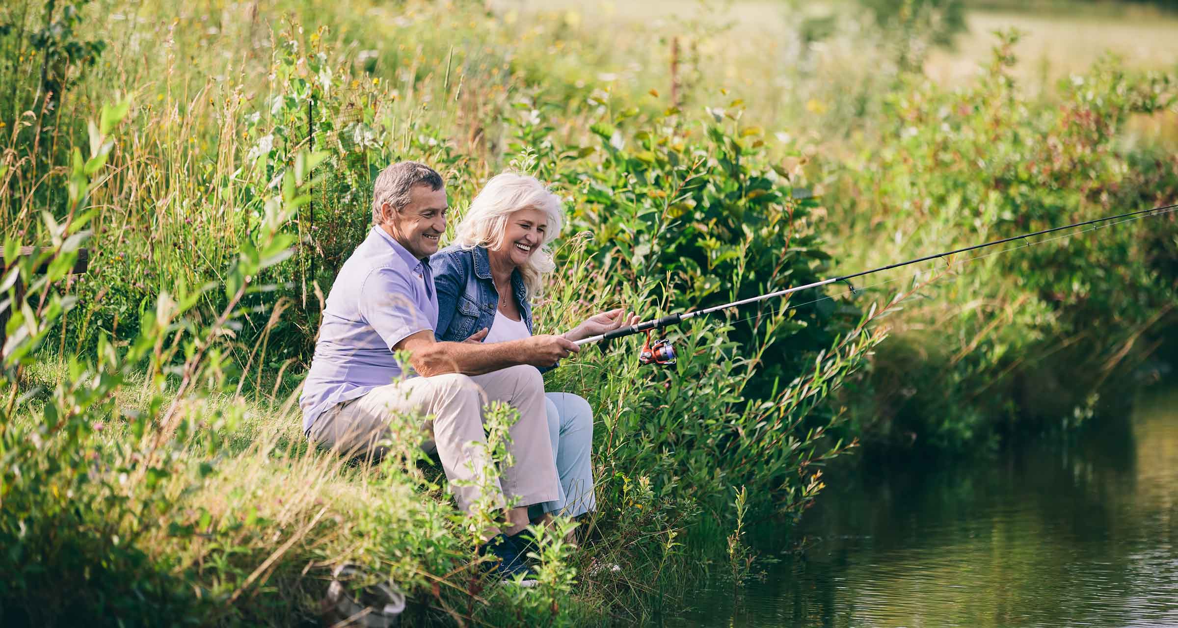 senior couple sitting by the edge of a river together fishing how annuities for retirement work oklahoma city ok